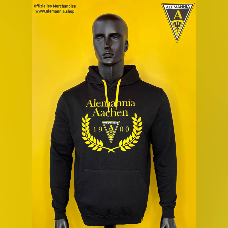 Mannequin wearing a black Alemannia Aachen hoodie with yellow logo and crest on a bright yellow background, front view.