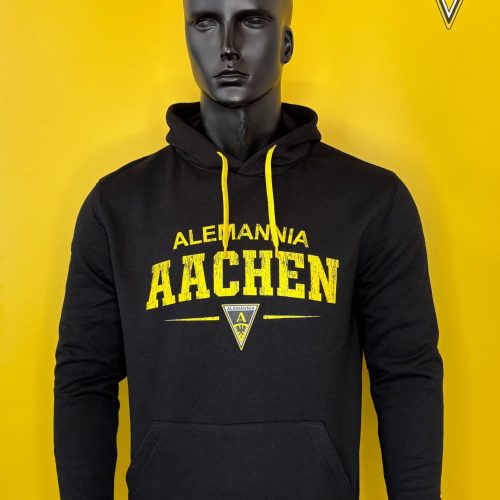 Black hoodie on a mannequin with yellow drawstrings; chest reads 'Alemannia Aachen' with a small emblem beneath, set against a yellow backdrop with the Alemannia logo in the top-right corner.