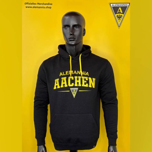 Black Alemannia Aachen hoodie on a mannequin, yellow 'AACHEN' print and team crest against a yellow backdrop.