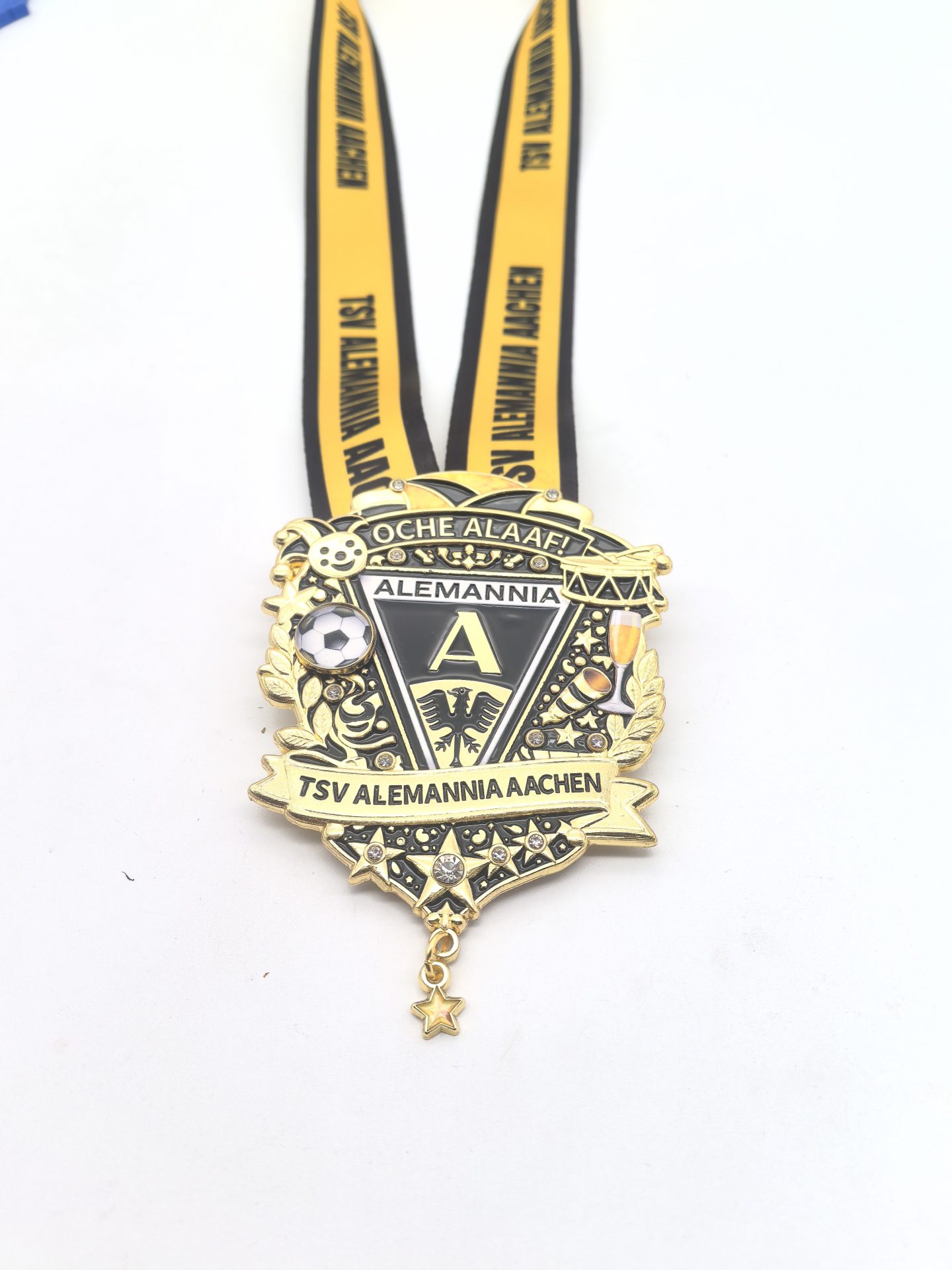 Gold and black medal for TSV Alemannia Aachen with crest, soccer ball, laurel motifs, and a yellow ribbon reading Alemannia Aachen hanging below
