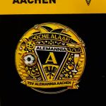 Gold Alemannia Aachen enamel pin badge featuring the crest with A and banners on a black background.