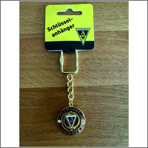 Gold-toned keychain featuring the Alemannia Aachen crest, a circular medallion on a short chain, with yellow packaging reading 'Schlüsselanhänger'