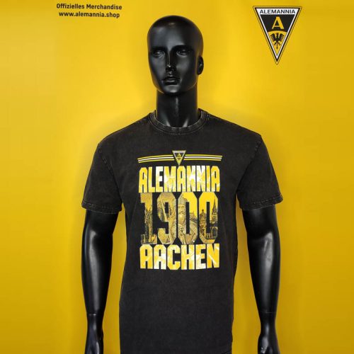 Mannequin wearing a black T-shirt with yellow 'Alemannia 1900 Aachen' logo on a bright yellow backdrop