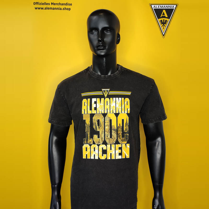 Mannequin wearing a black T-shirt with yellow 'Alemannia 1900 Aachen' logo on a bright yellow backdrop
