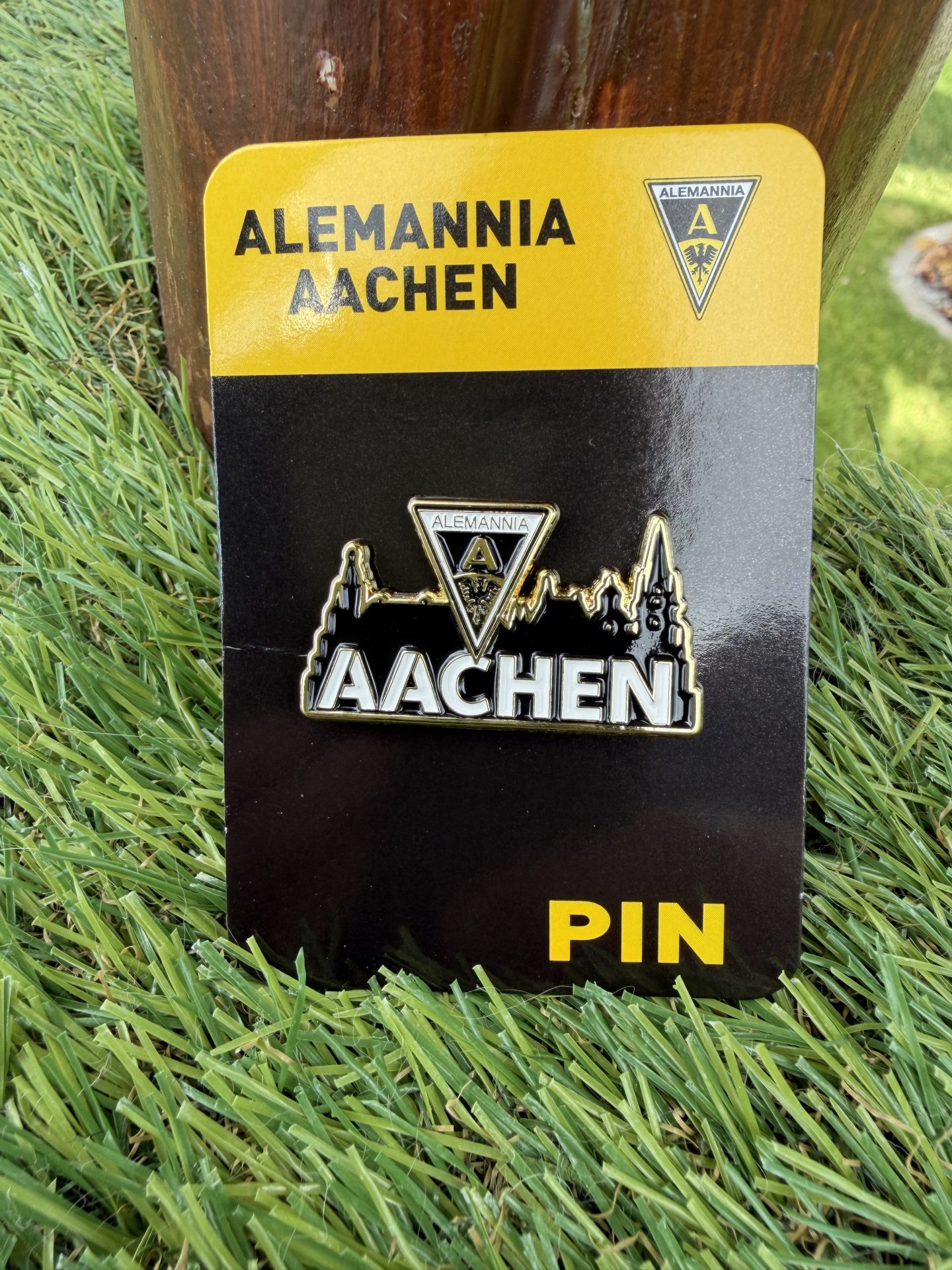 IMG_9298 - Alemannia Shop Enamel pin with Alemannia Aachen crest on a yellow-and-black card