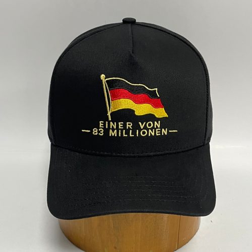 Black cap with an embroidered waving German flag in gold, red, and black and the text “EINER VON 83 MILLIONEN.”